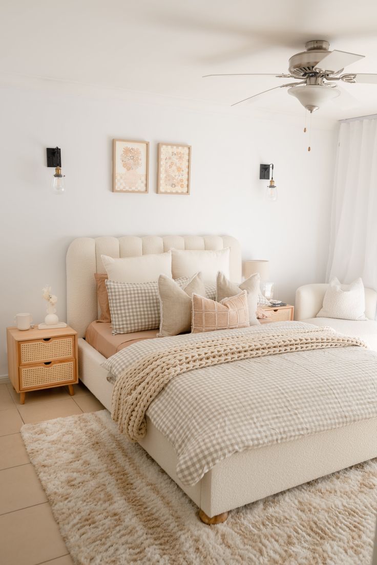 a bedroom with a bed, dresser and ceiling fan