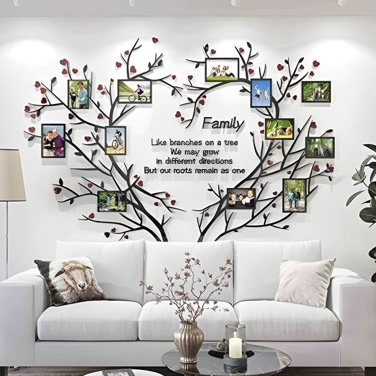 a living room with white couches and pictures on the wall above it, along with a coffee table