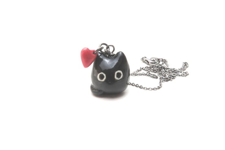 "Product Information A simple and adorable necklace charm to match your mismatched earrings: https://www.etsy.com/listing/602226431/black-cat-red-heart-earrings-mismatched?ref=shop_home_active_11 A tiny red heart is attached to this necklace pendant! Chains available: Gunmetal, Sterling Silver, Gold-Filled Dimensions The charm is about 5/8\" (1.6 cm) tall Chains available in 18, 20, 22, 24, and 26 inches Materials Porcelain Clay Underglaze Colors Mid-Fire Glaze Care Instructions While porcelain Black Cat Jewelry, Black Cat Necklace, Black Cat Lover, Red Heart Earrings, Ceramic Cat, Cat Charm, Mismatched Earrings, Cat Lover Gift, Valentines Necklace