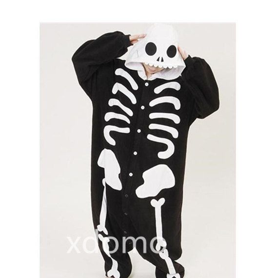 a man in a skeleton costume is covering his face