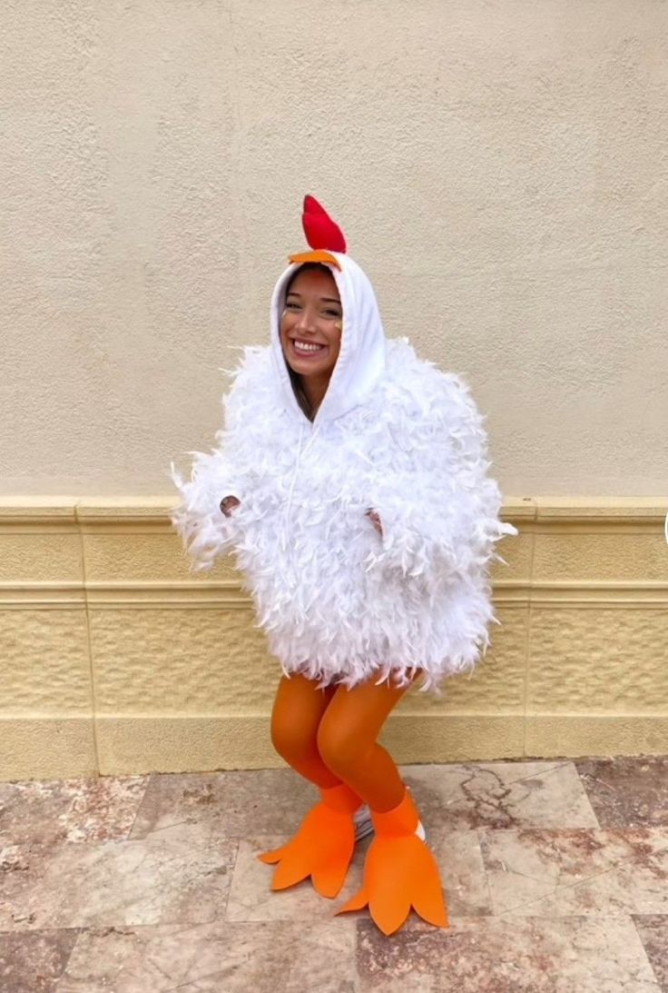 a woman in a chicken costume sitting on the ground