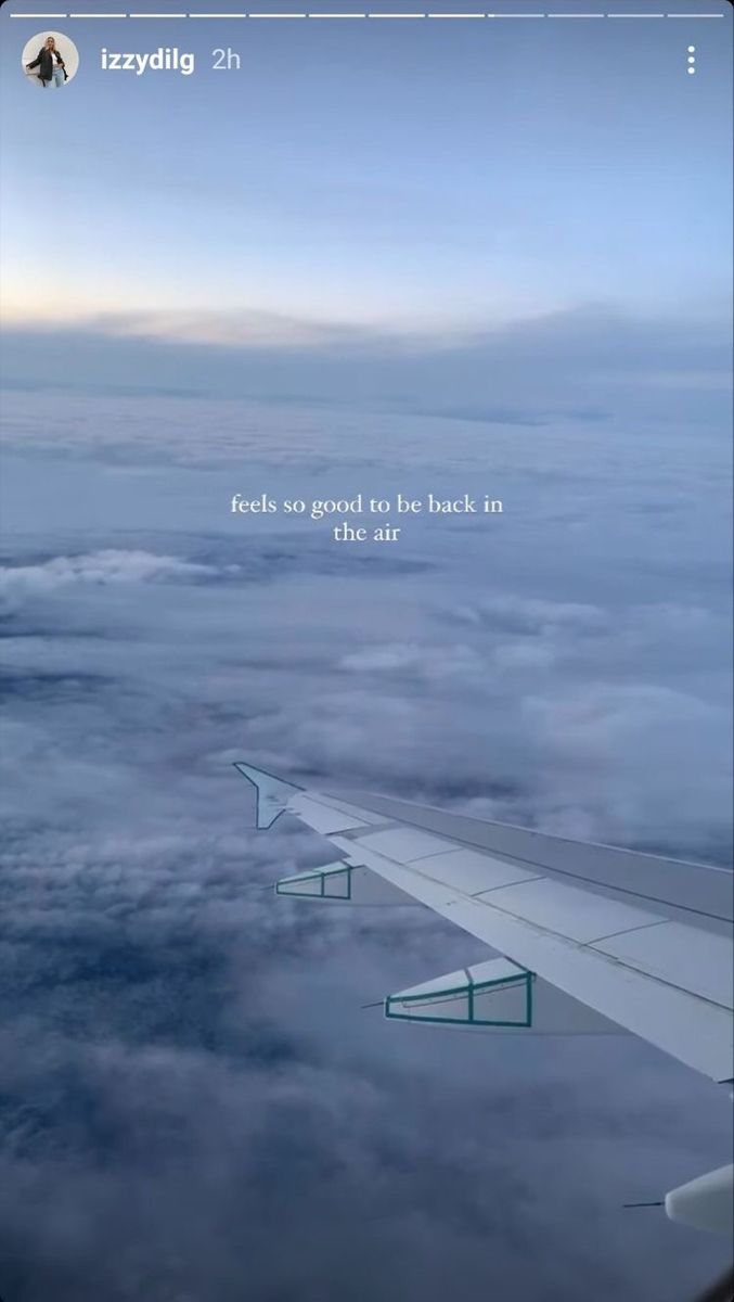 an airplane wing flying above the clouds with a quote on it's side that reads, feet so good to be back in