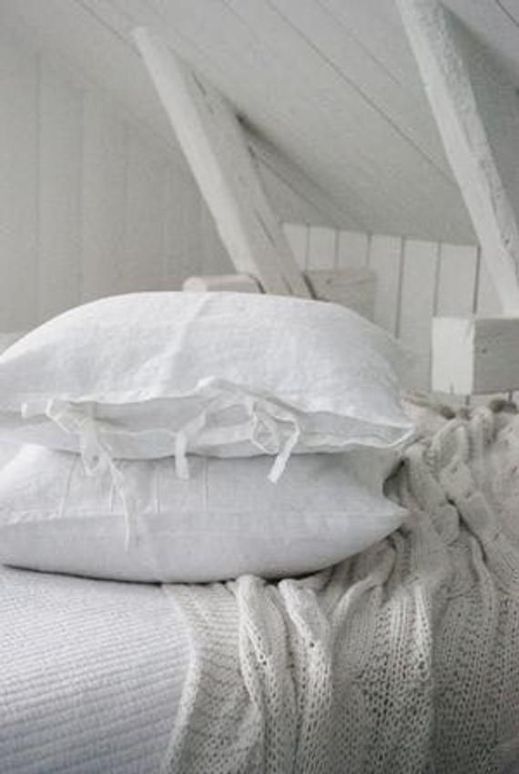 two white pillows stacked on top of each other