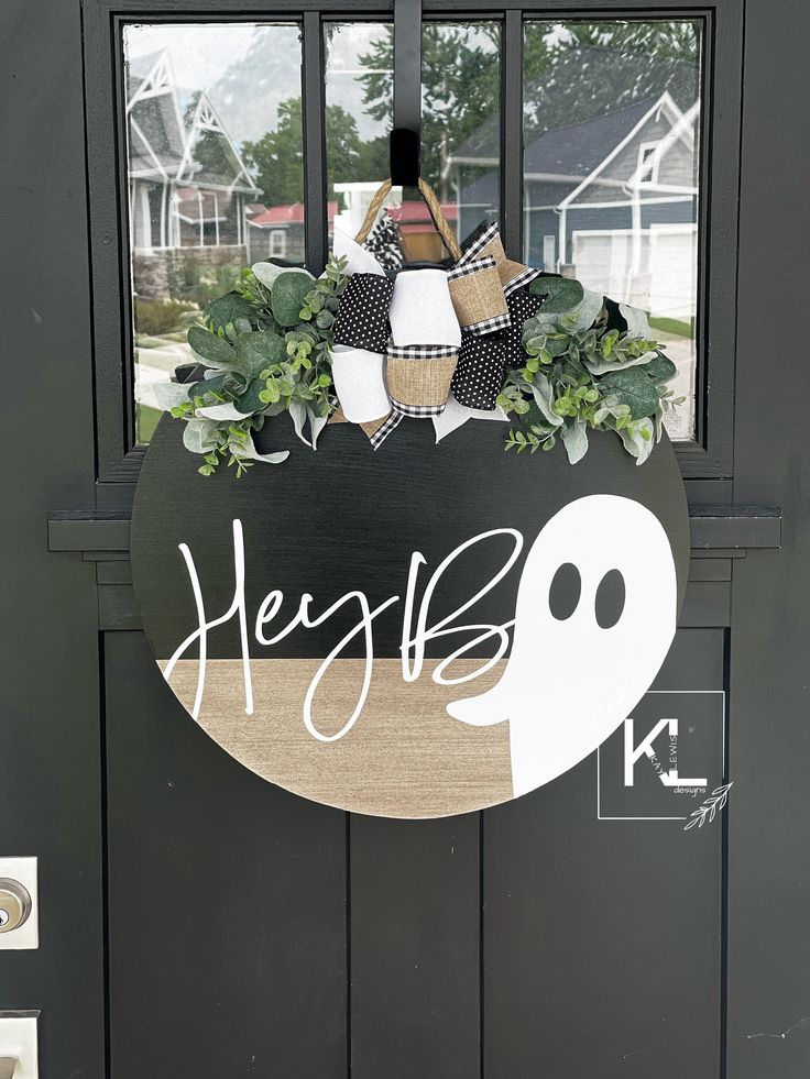 a black door with a sign that says hello boo on it