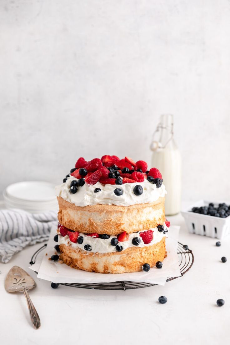 a cake with berries and cream on top