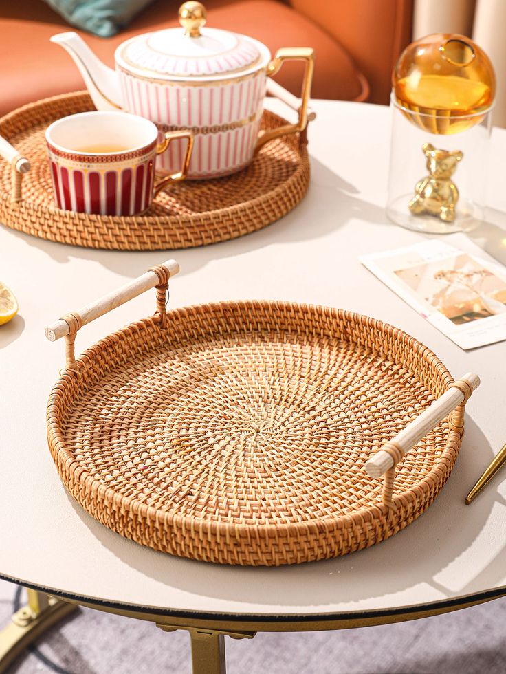 two wicker trays sitting on top of a white table next to each other