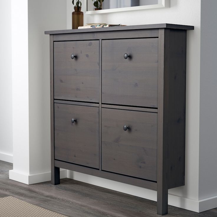 a wooden dresser with four drawers and a mirror above it