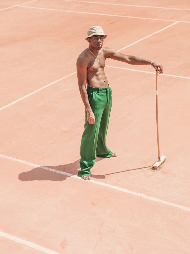 a man standing on a tennis court holding a racquet in his right hand