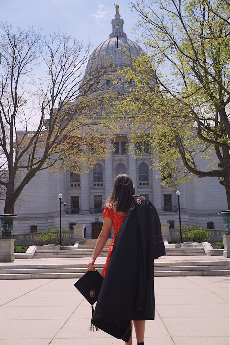 a woman standing in front of a large building