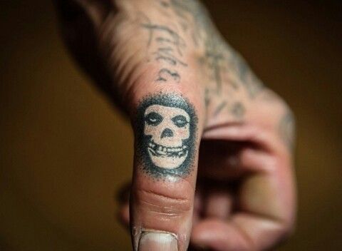 a hand with a skull tattooed on it