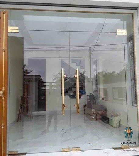 an open glass door leading to a living room