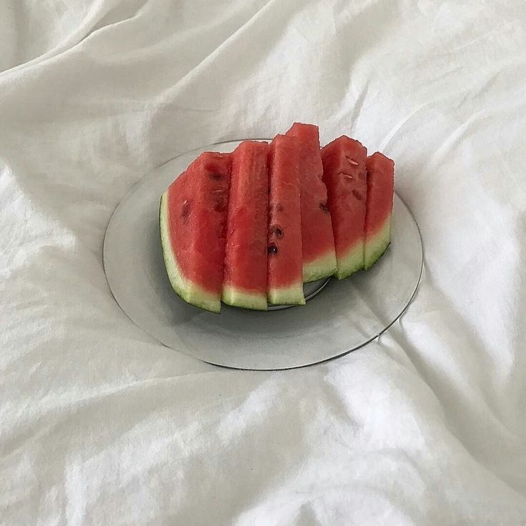 slices of watermelon sit on a glass plate