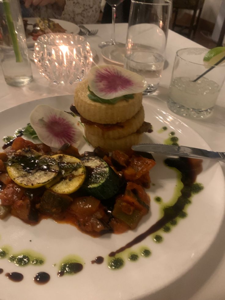 a white plate topped with food on top of a table