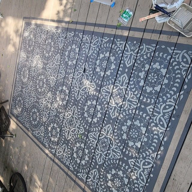 a bicycle parked next to a wall with an intricate design on it's side