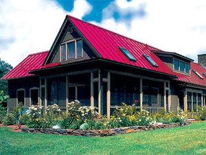 a large house with a red metal roof