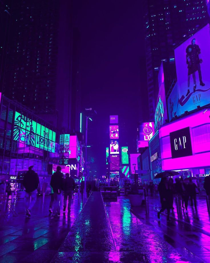 people are walking in the city at night with neon lights on buildings and billboards