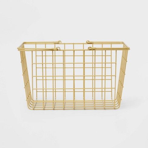 a gold wire basket with handles on the front and side, against a white background