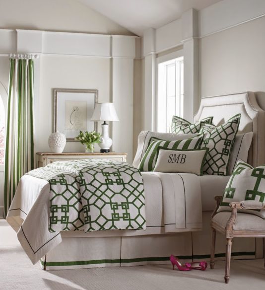 a bedroom with white walls and green accents