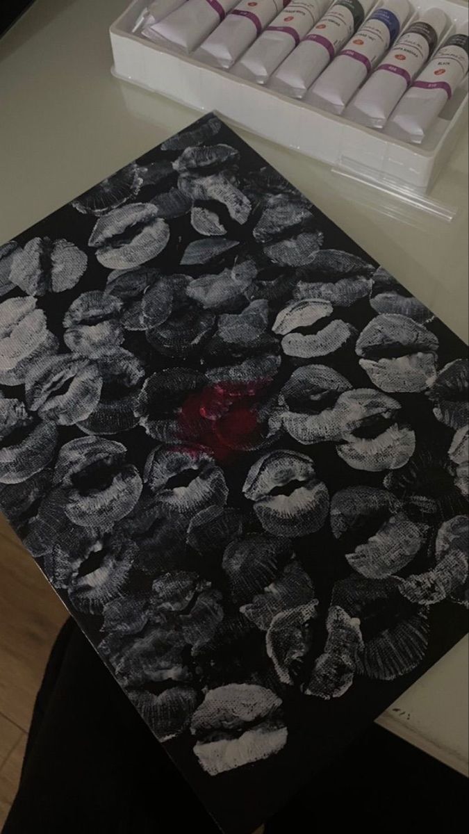 a black and white table topped with lots of paint