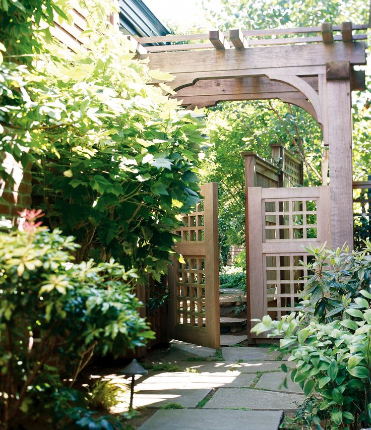 an archway in the middle of a garden