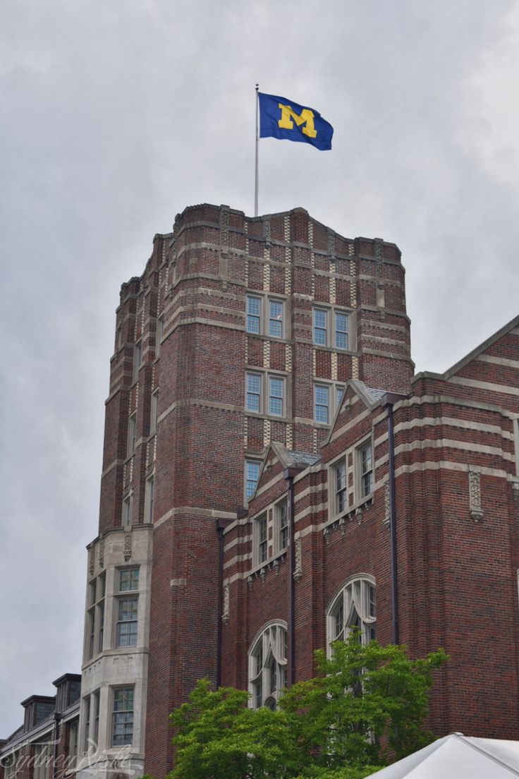 an old brick building with a flag on top