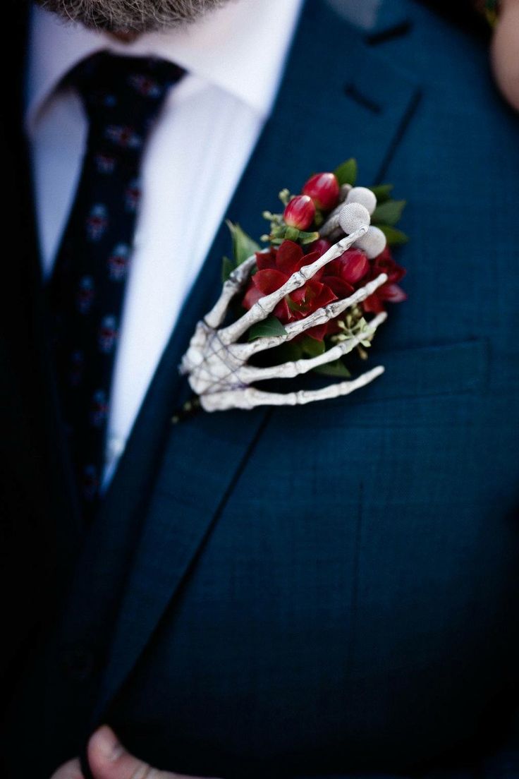 a man in a suit with a boutonniere on his lapel