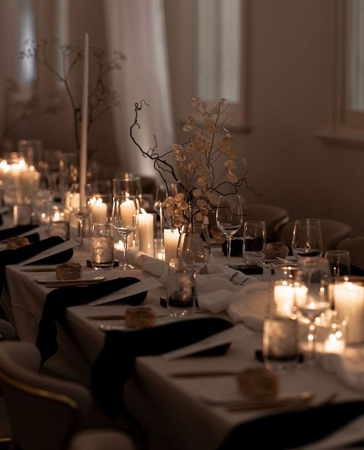 a long table is set with candles and place settings