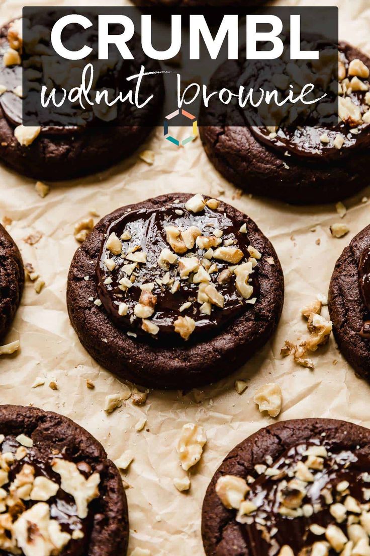 chocolate crumbl walnut brownie cookies on top of parchment paper with the words crumbl written in white