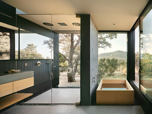 a bathroom with a large window and a tub next to it on the side of the wall