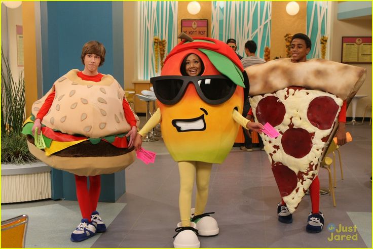 two people in costumes are holding large hamburgers and pizza