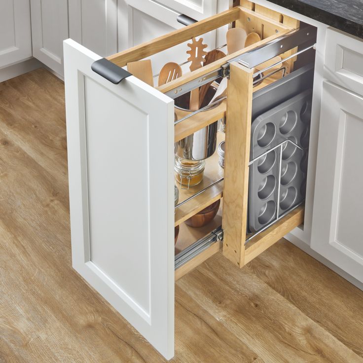 an open cabinet with utensils in it