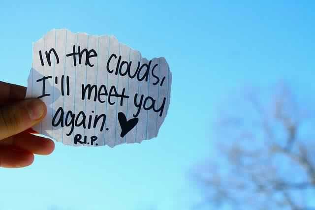 someone holding up a piece of paper that says in the clouds i'll meet you again