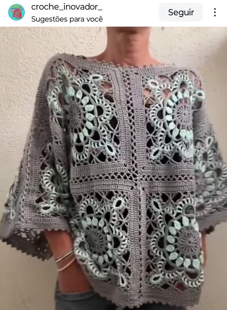 a woman is wearing a crocheted sweater