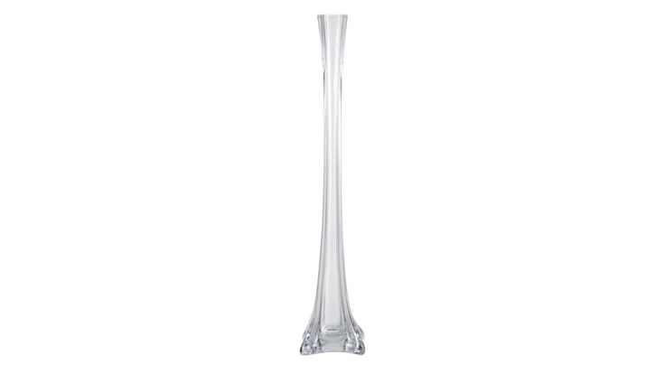 a tall glass vase sitting on top of a table