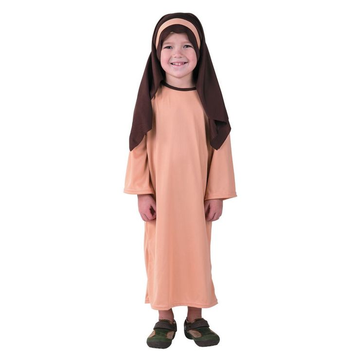 a little boy wearing a nun costume and smiling at the camera with his hands in his pockets