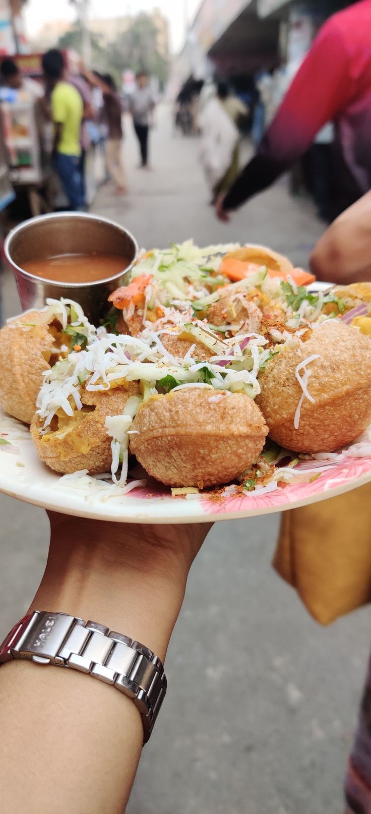 a person holding a plate with food on it