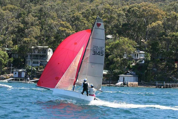 two people on a sailboat in the water