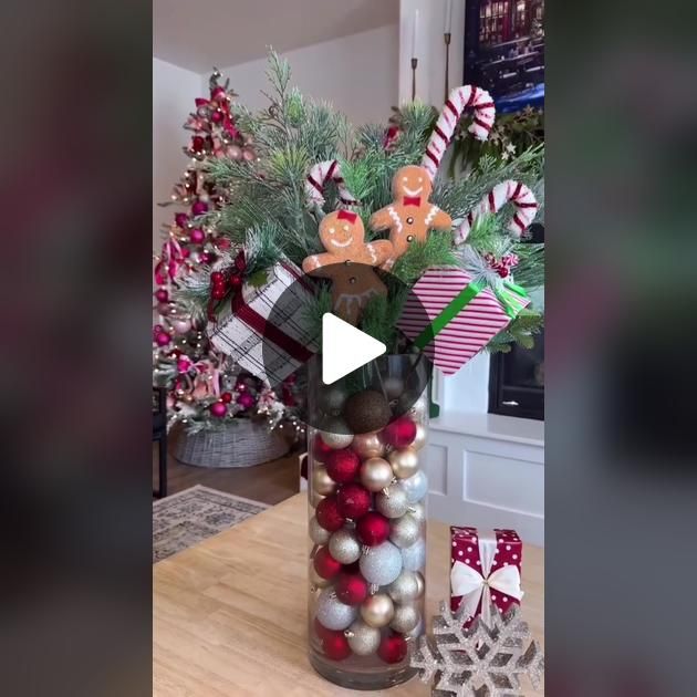 a vase filled with christmas decorations on top of a wooden table