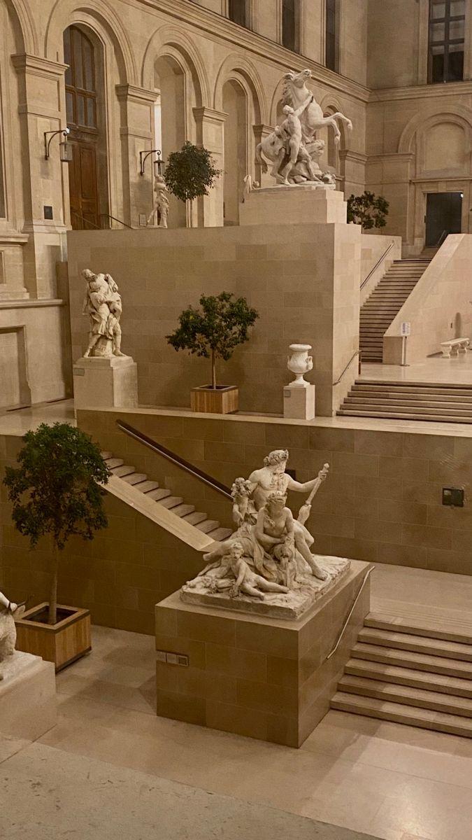 an indoor area with statues and stairs