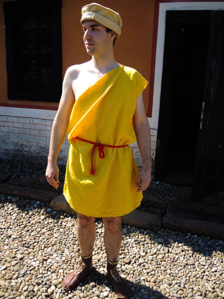 a man in a yellow towel is standing outside