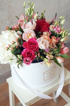 a bouquet of flowers in a white bucket