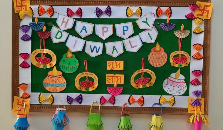 colorful paper decorations are hanging on the wall above a green board with words happy diwal