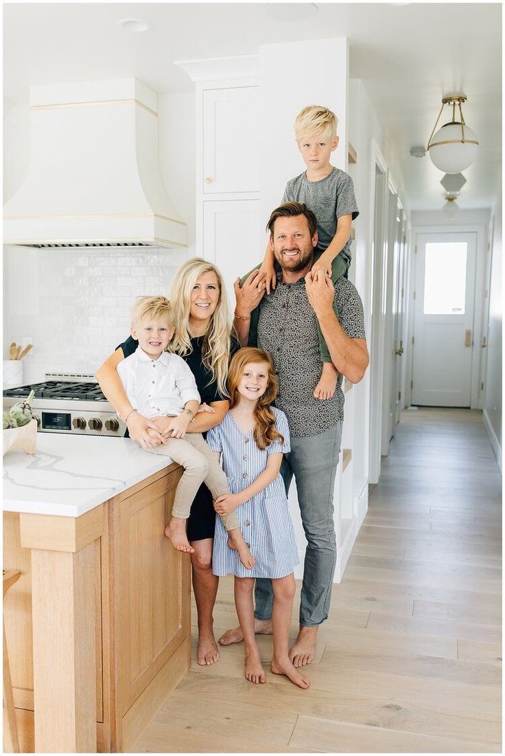 a family posing for a photo in the kitchen