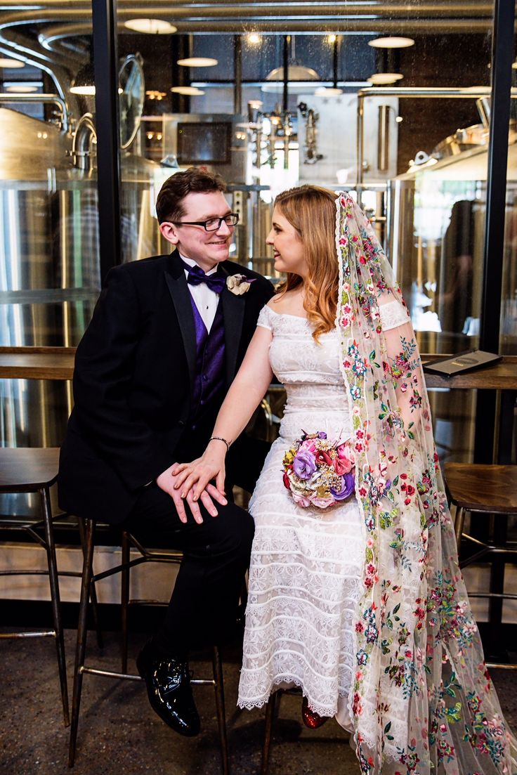 a bride and groom are sitting in chairs