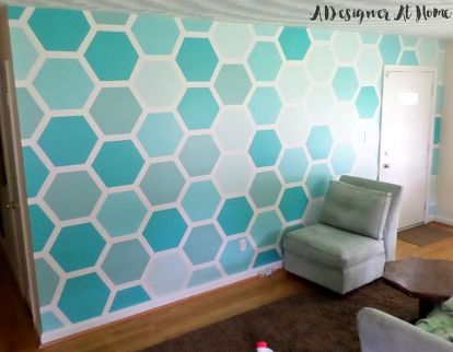 a living room with blue and white hexagonal wallpaper