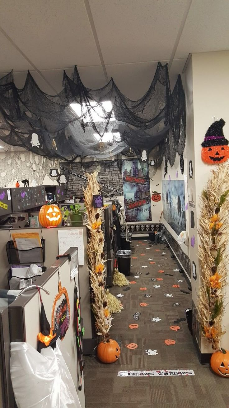 an office decorated for halloween with pumpkins and decorations