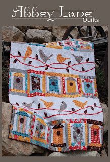 a quilted blanket with birds on it