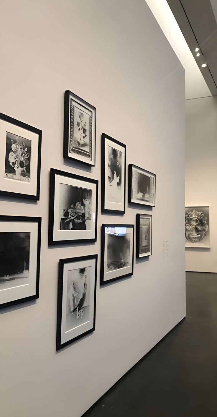 black and white photographs are hung on the wall