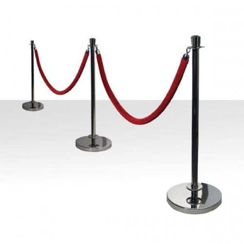 a red rope is on top of two black poles and one has a white background