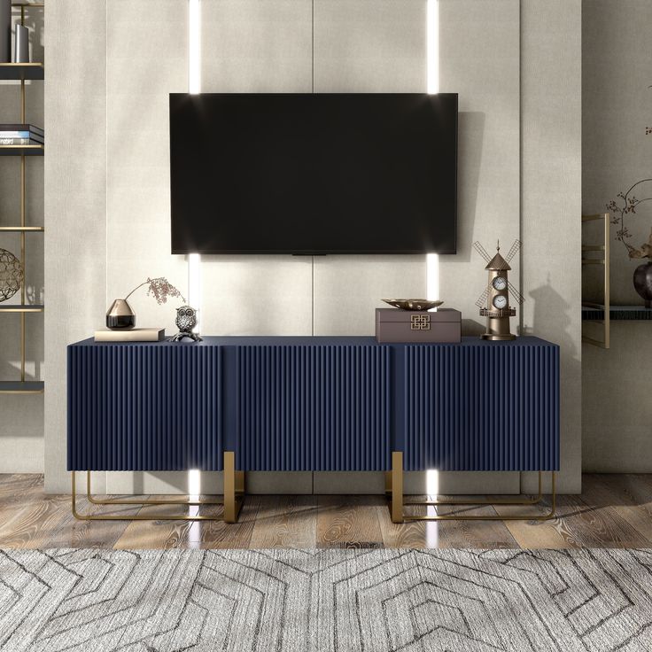 a living room with a large tv mounted on the wall and two blue sideboards